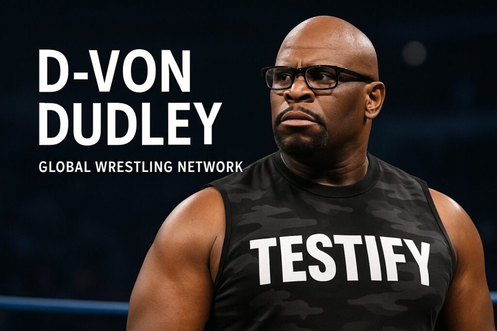 Bald man in glasses wearing TESTIFY shirt